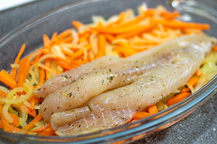 Fish fillet with carrots and onions