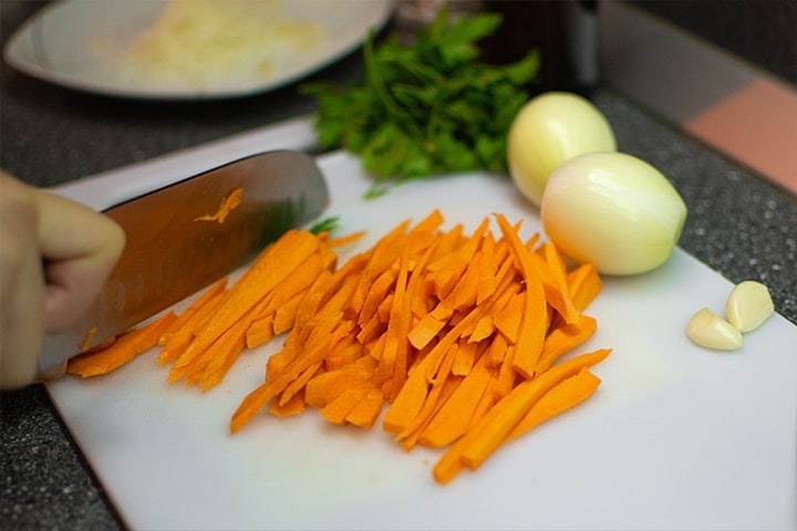 Slicing carrots on a cutting board