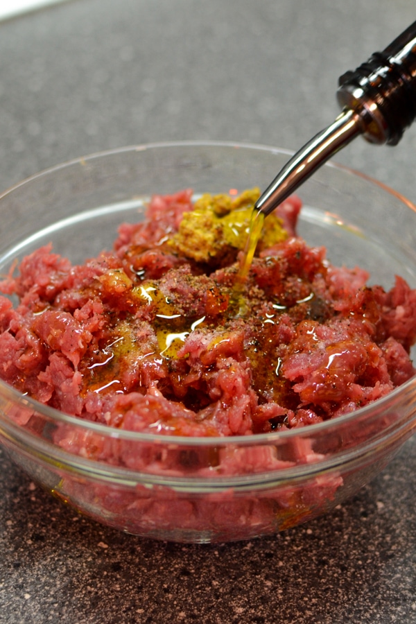 Ground beef meat with salt, pepper and mustard.