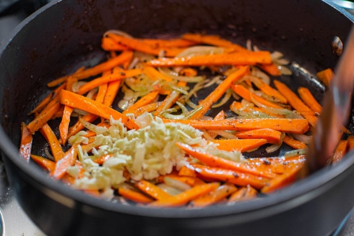 Fried carrots, onions and ginger in a pan