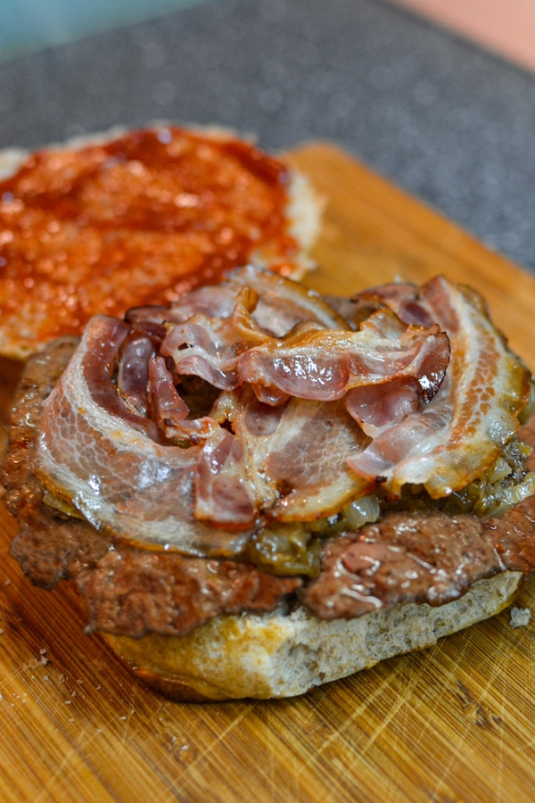 Homemade burger with bacon, beef meat and ketchup.