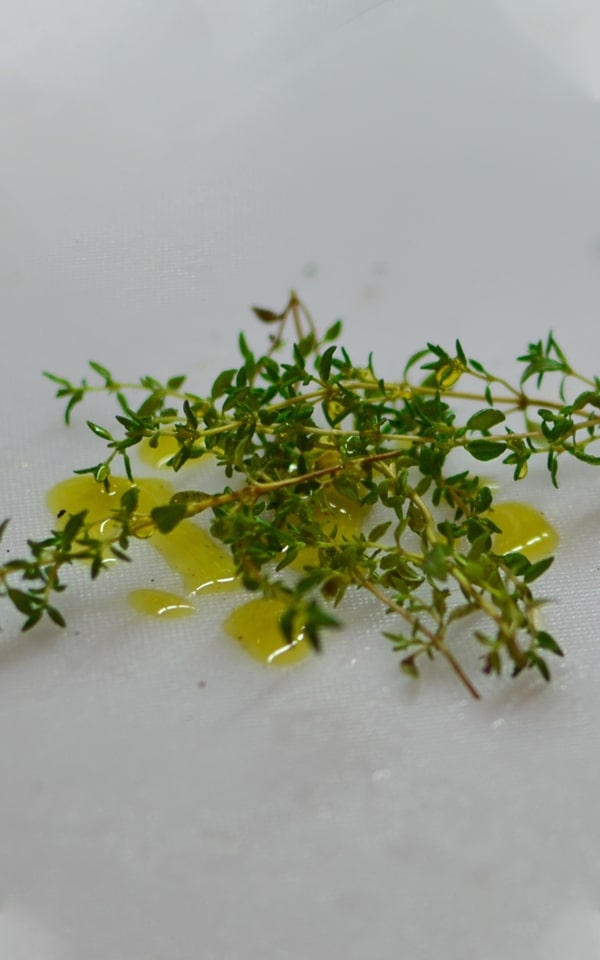 Thyme with olive oil on a cutting board