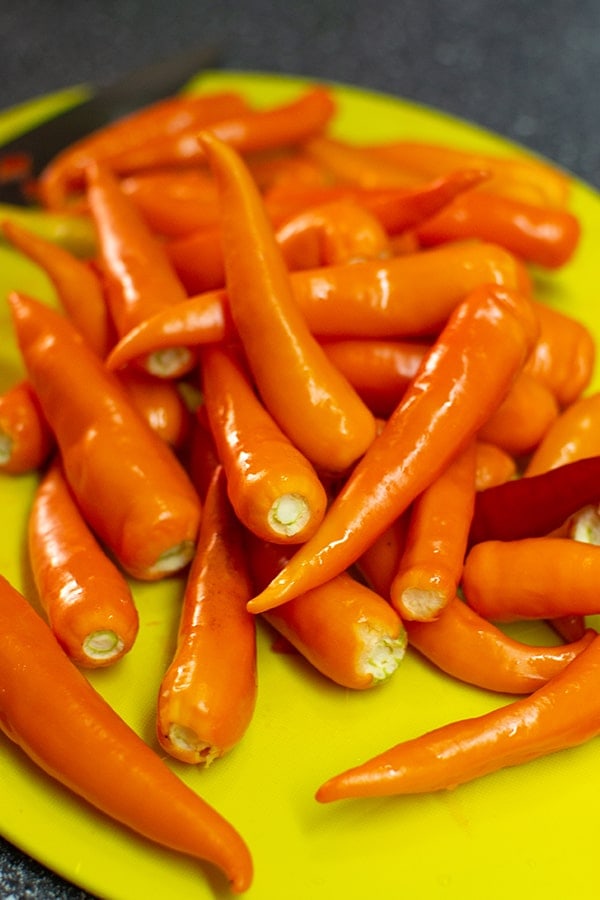 Orange and red chilli peppers without stems.
