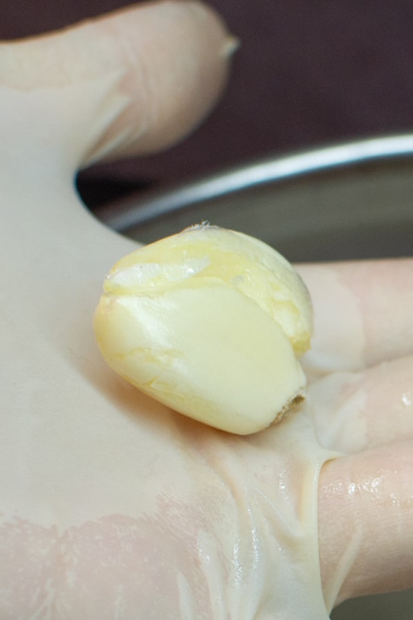 Crushed garlic in a hand.