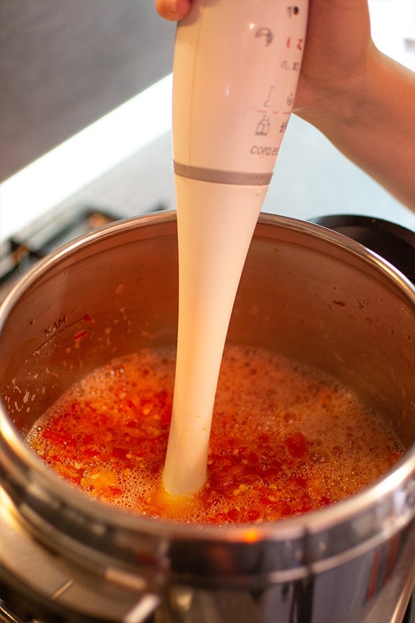 Mixing chily pepper sauce in a pan.
