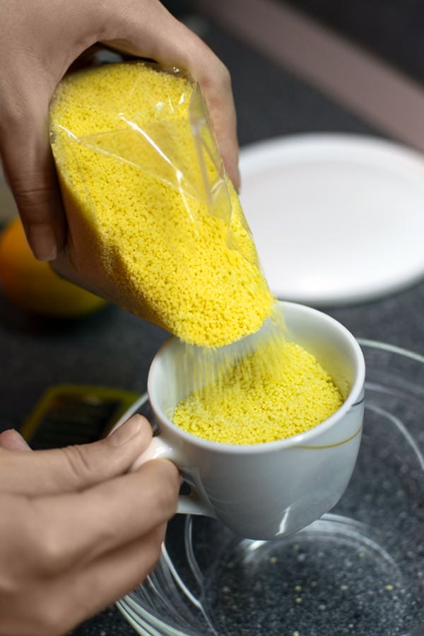 Pouring Couscous to a white cup