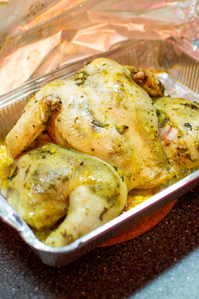 Roasted chicken on an aluminium tray.