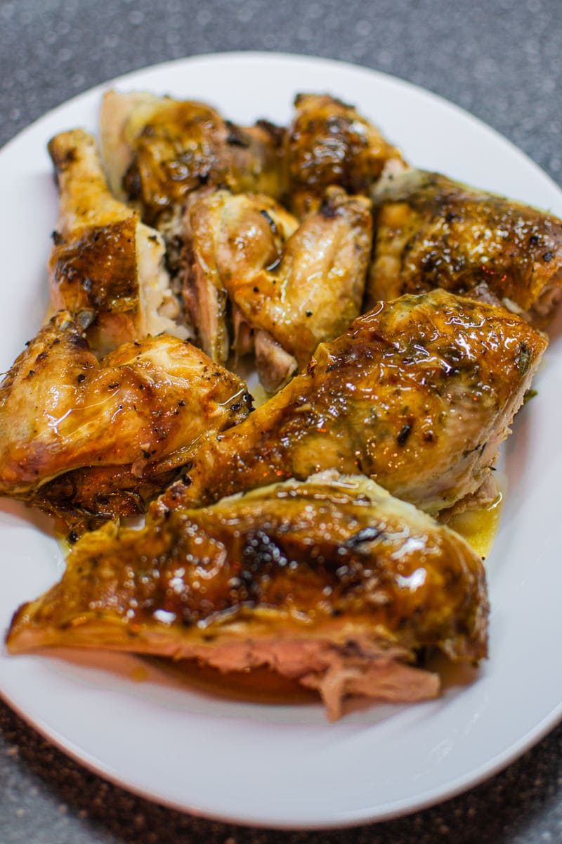 Juicy roasted chicken on white plate.