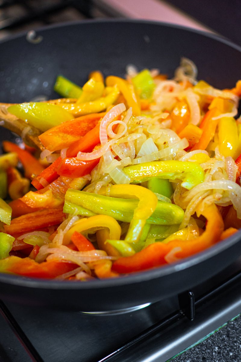 Sliced bell peppers with sliced onions.