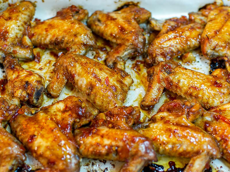 Delicious chicken wings on a white pan