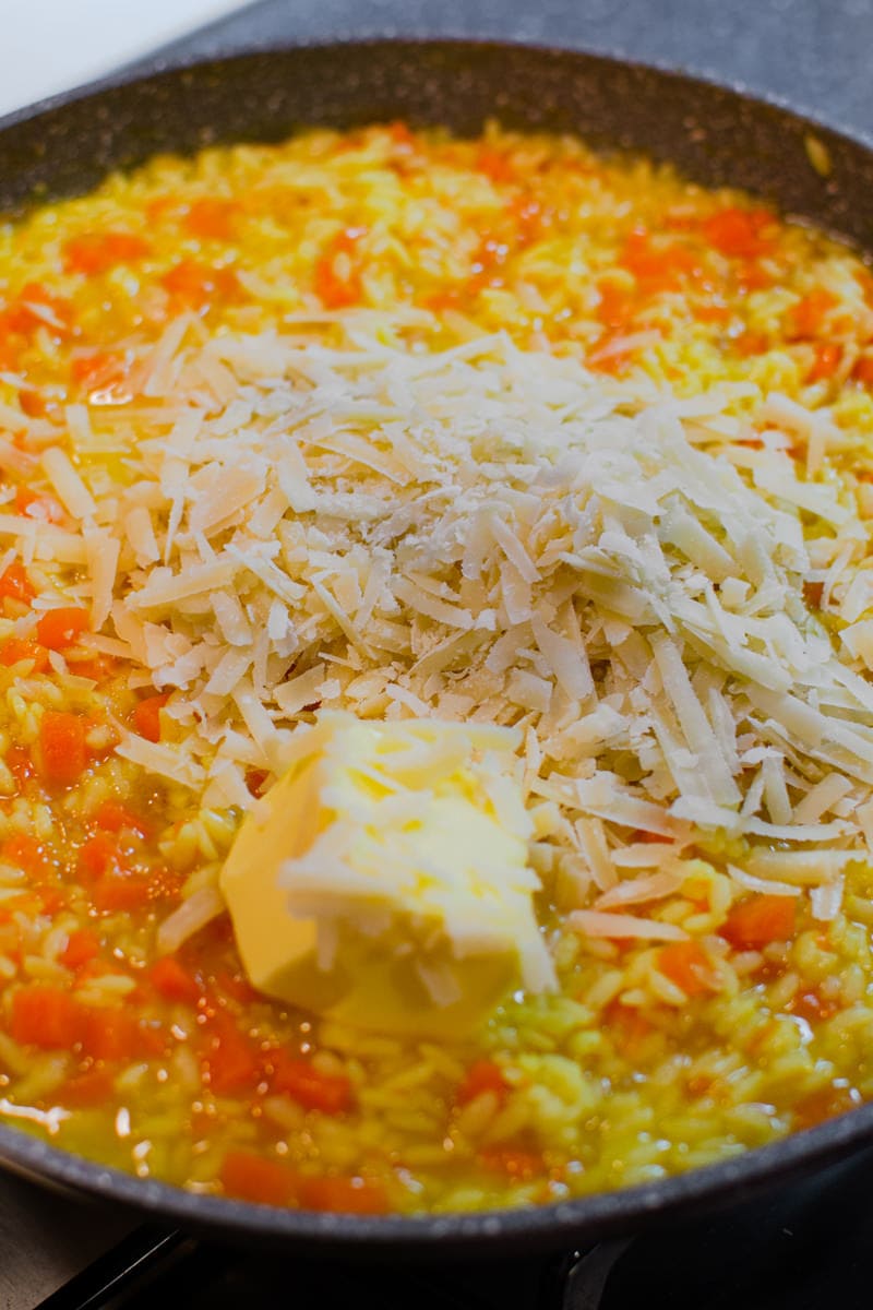Adding butter and cheese in a pumpkin risotto