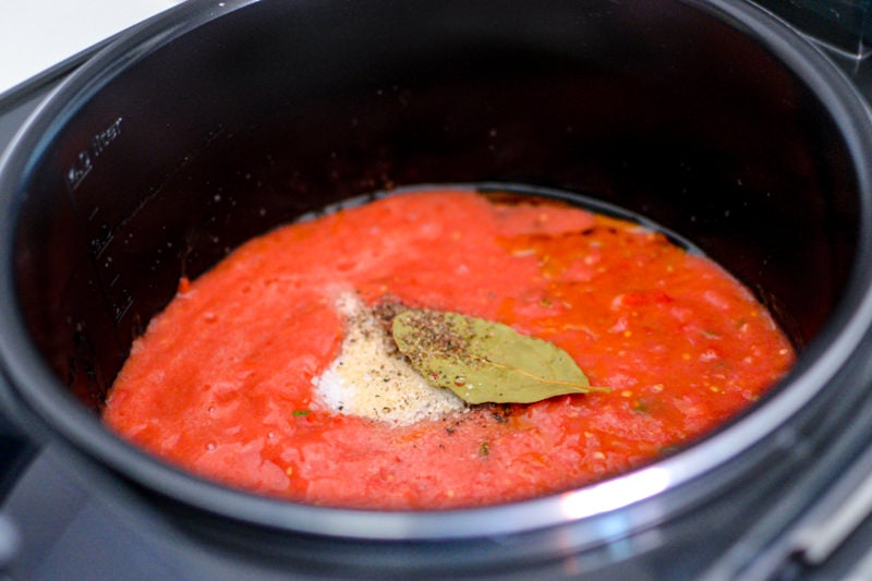 Blended basic tomato sauce with a bay leaf into a dark pan