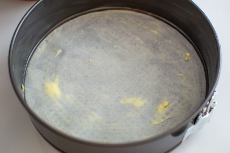 Gray baking pan greased with butter.