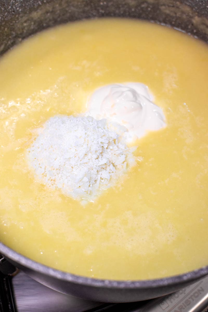 Adding cheese and sour cream in a cauliflower leek soup.