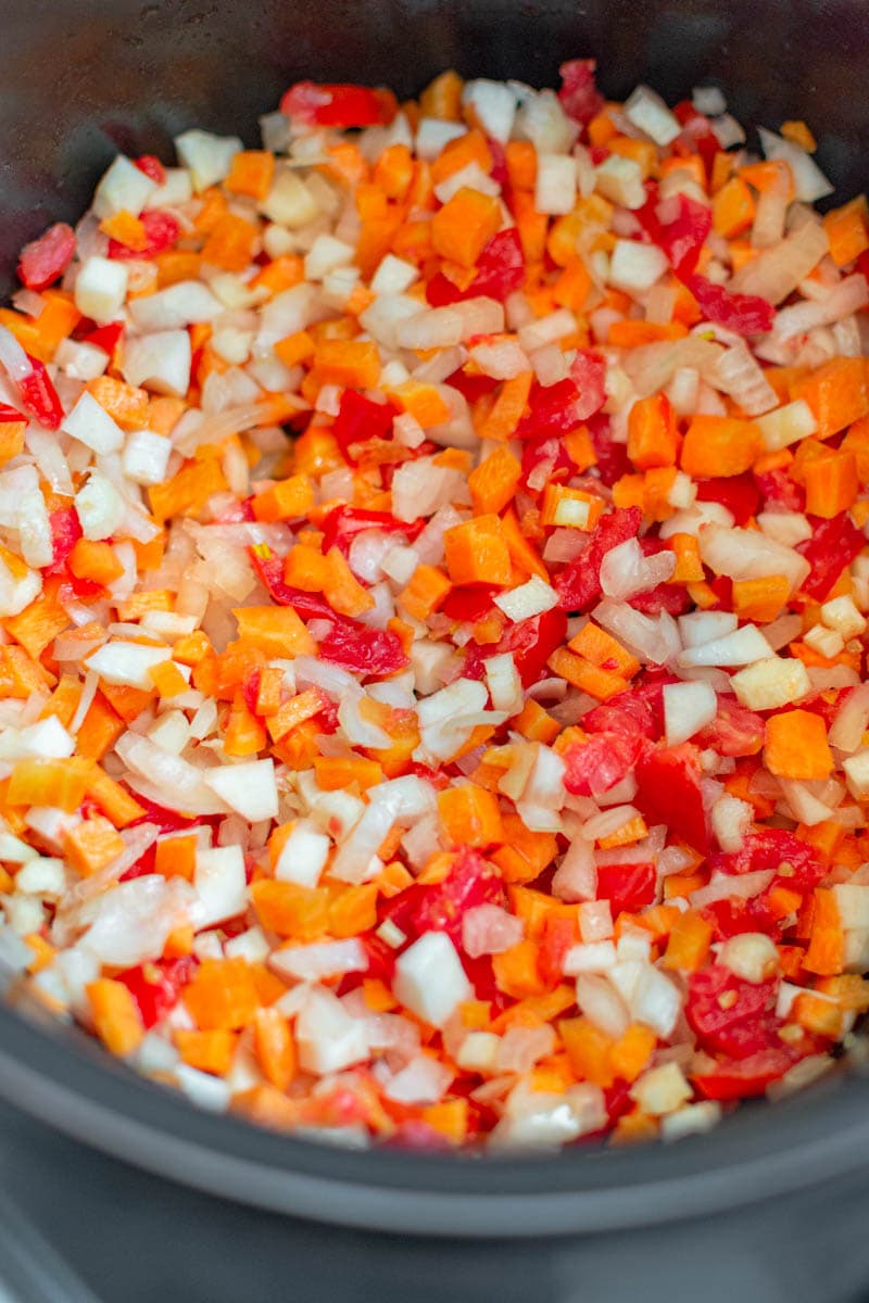 Chopped vegetables in a dark gray pan.