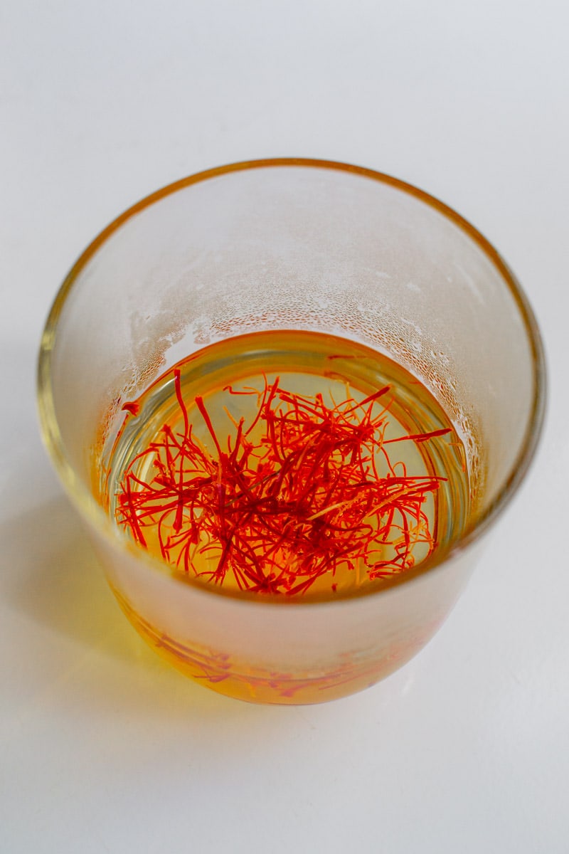 Saffron Threads in a transparent glass with hot water.