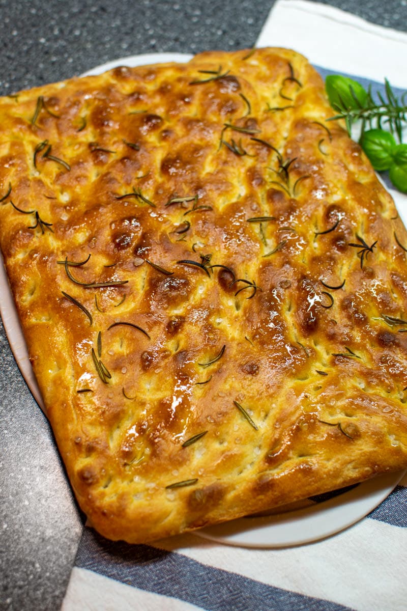 Classic Italian Focaccia with Rosemary on a kitchen towel.