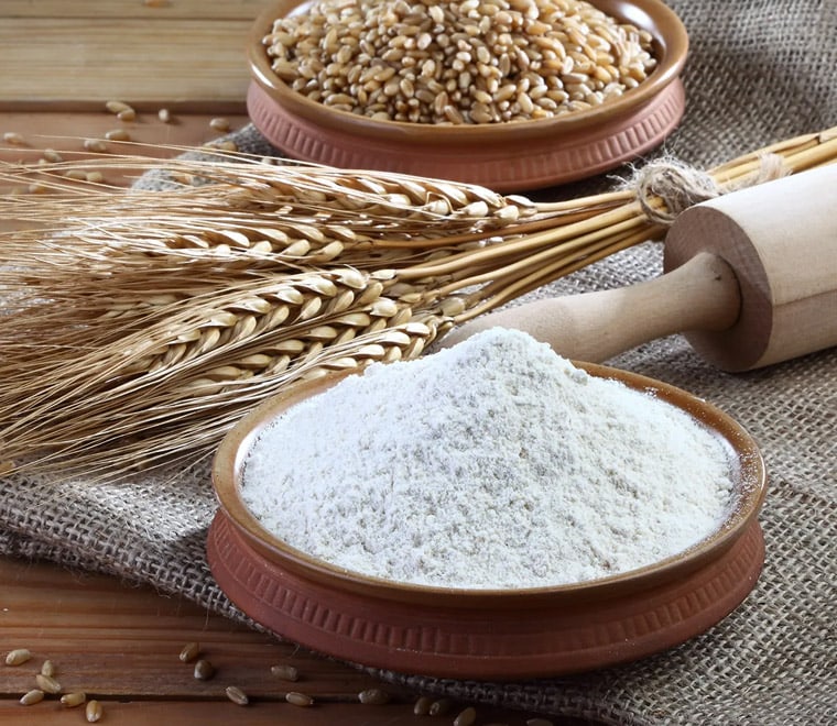 Wheat Flour on the table with wheat ears.