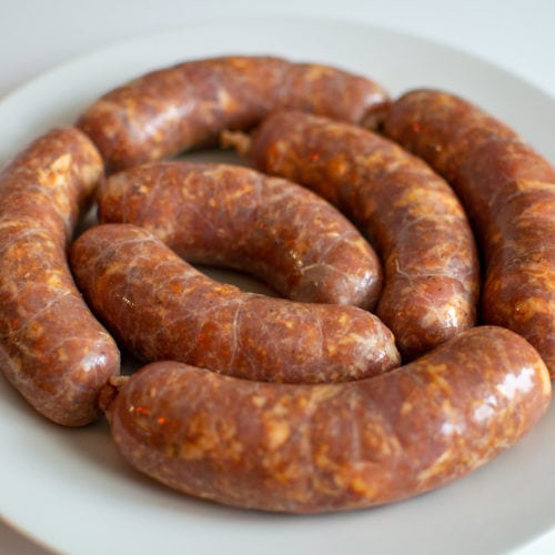Homemade Sicilian Sausages on white plate.