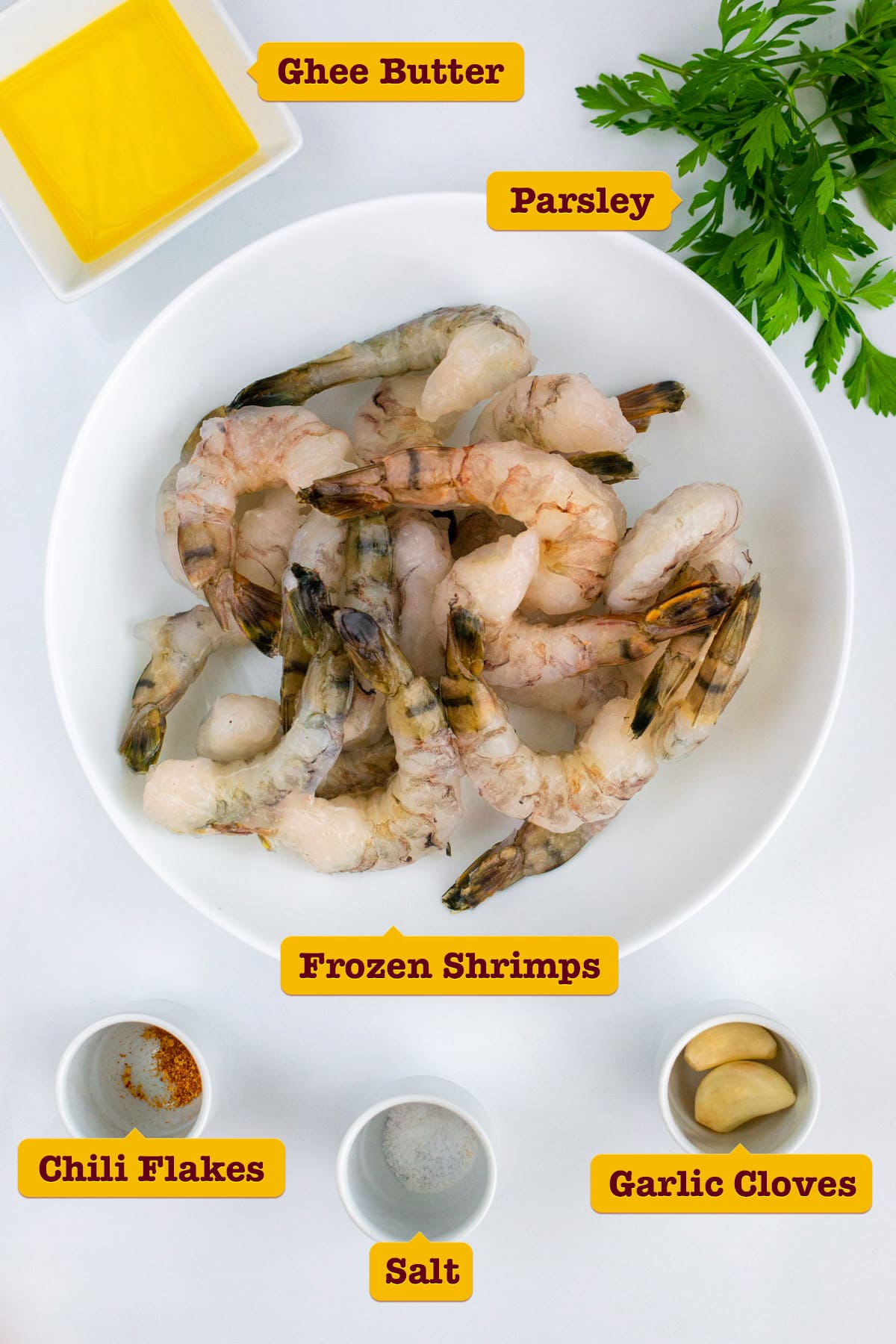 Frozen shrimps with chili flakes, garlic cloves, parsley and ghee butter.