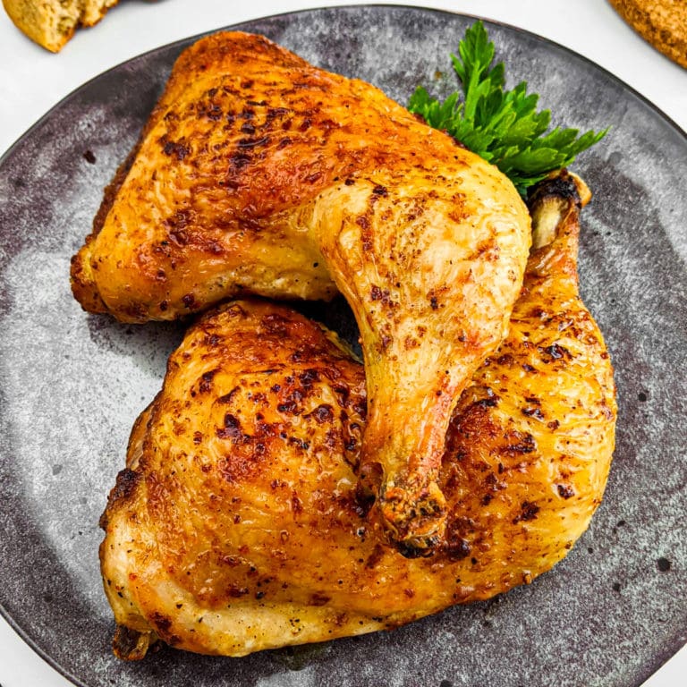 Roasted Chicken Quarters on a gray plate.
