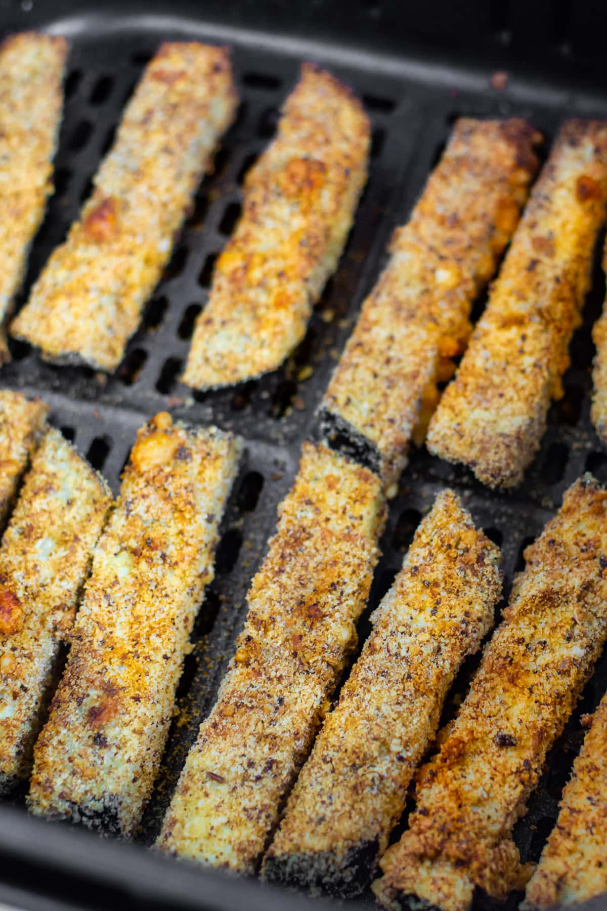 Macro view of eggplant fries with bread crust.