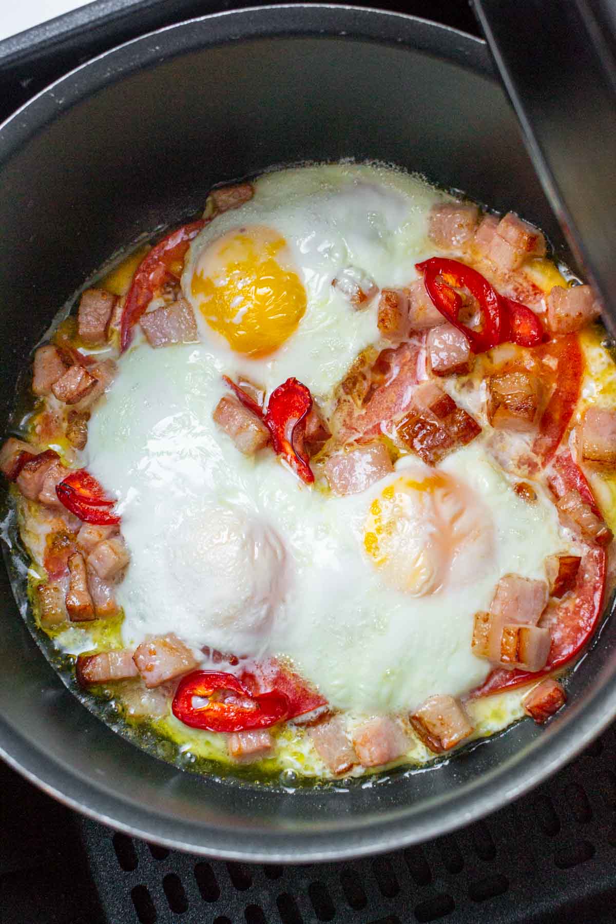 Fried Eggs With Bacon and Red peppers in Air Fryer.