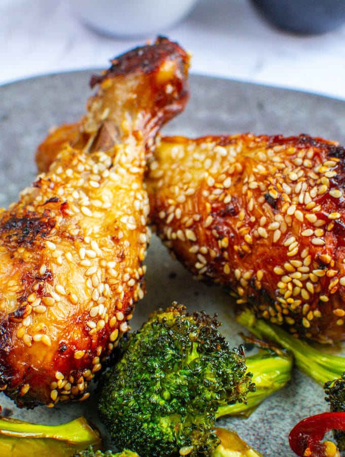Crispy sesame chicken with broccoli on a plate.