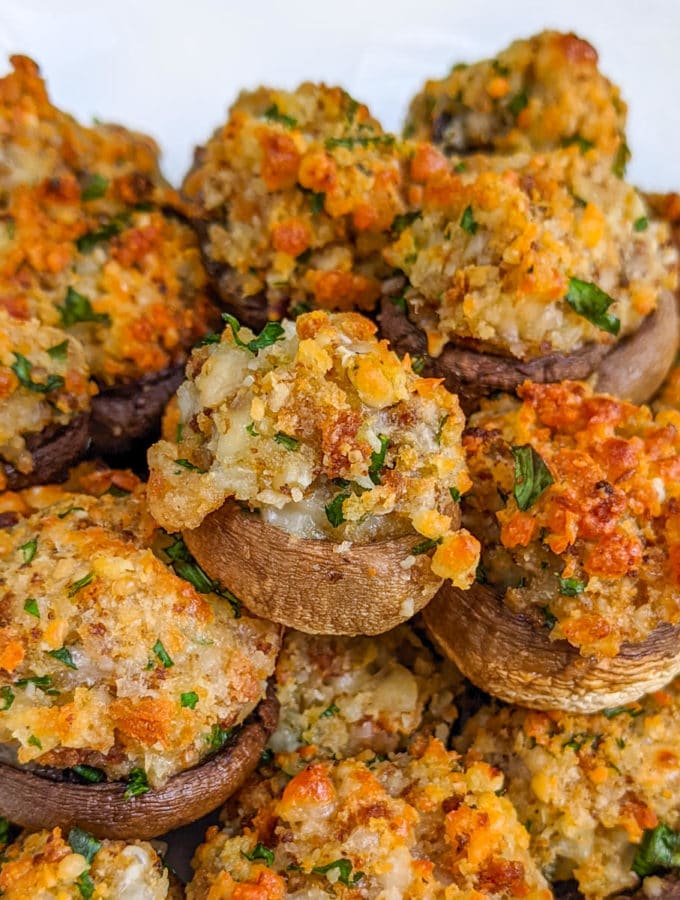 Close details of stuffed mushrooms with breadcrumbs and mozzarella.