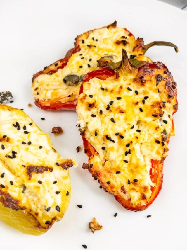 Bell pepper boats with cream cheese on white plate.