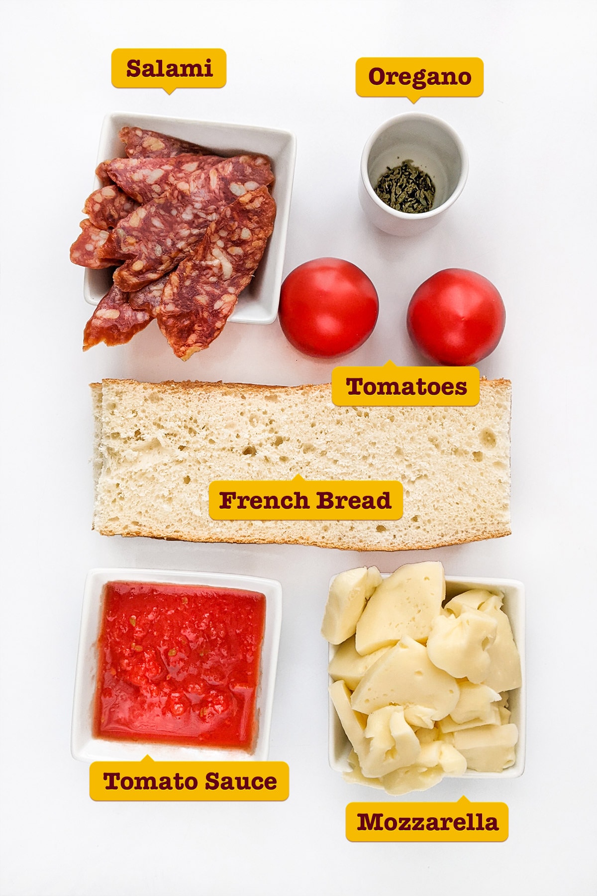 Ingredients for the french bread pizza on a white table.