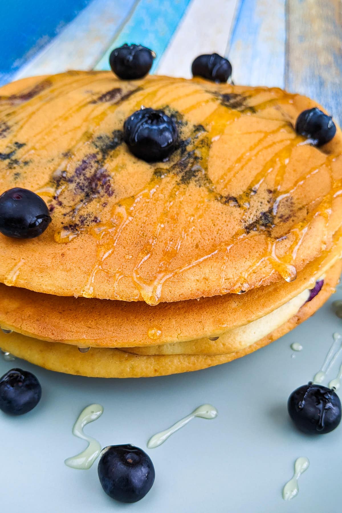 Homemade pancakes with honey and blueberries.