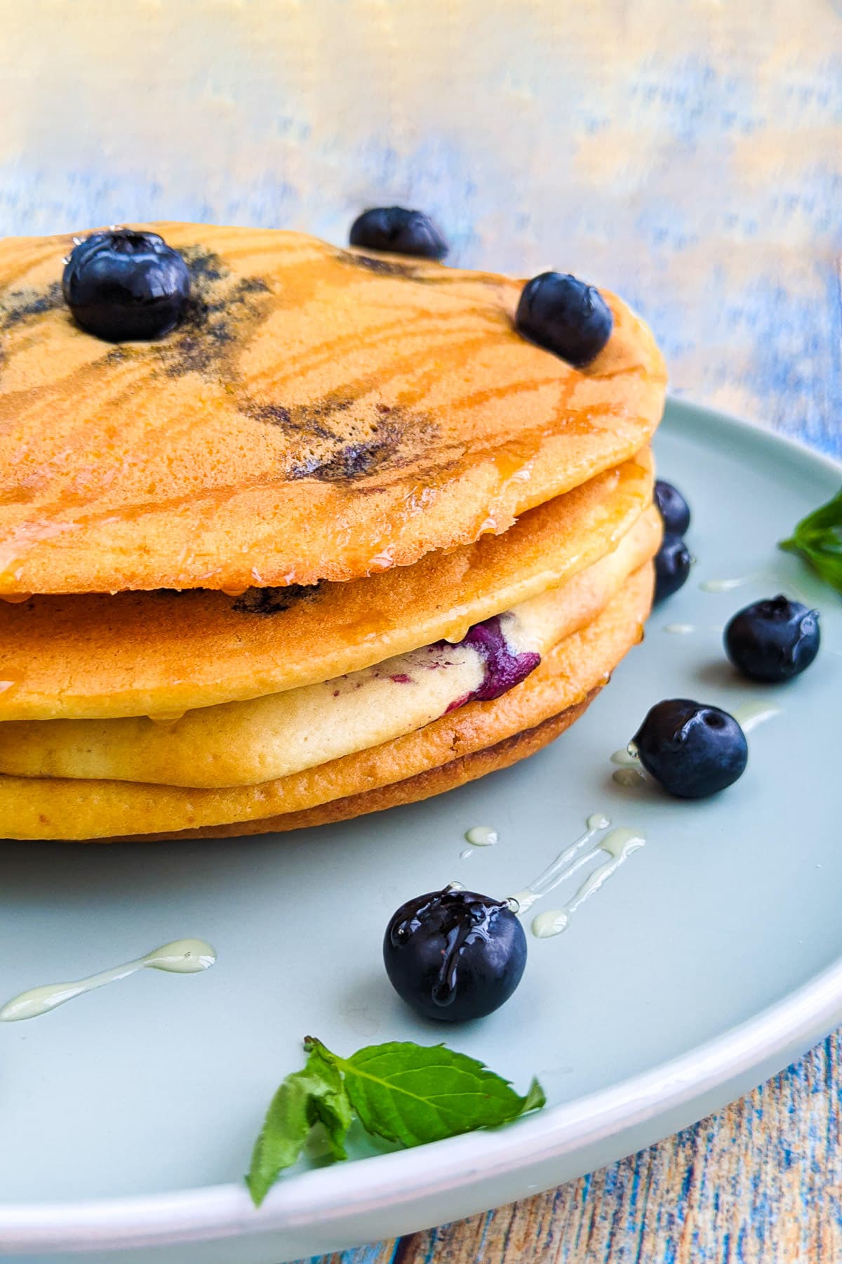 Perfect homemade air fryer pancakes with blueberries and honey.