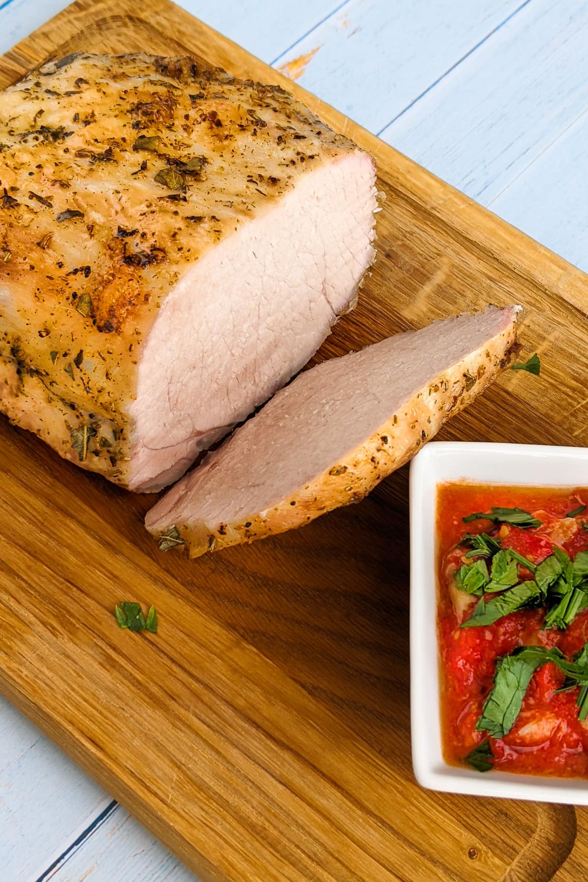 Slices of pork loin with homemade tomato sauce.