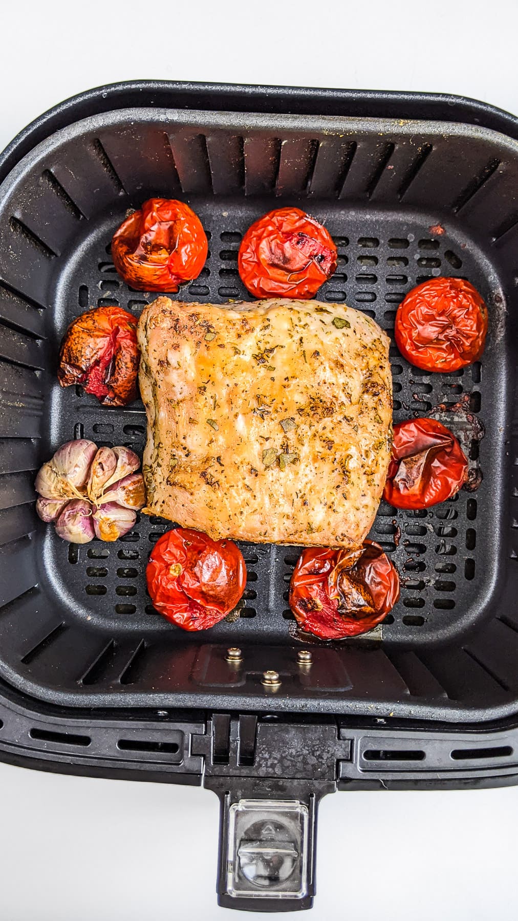 Air Fried Pork Loin with tomatoes in air fryer.