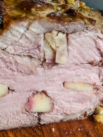 Close look of juicy air fryer roast pork with apple slices.