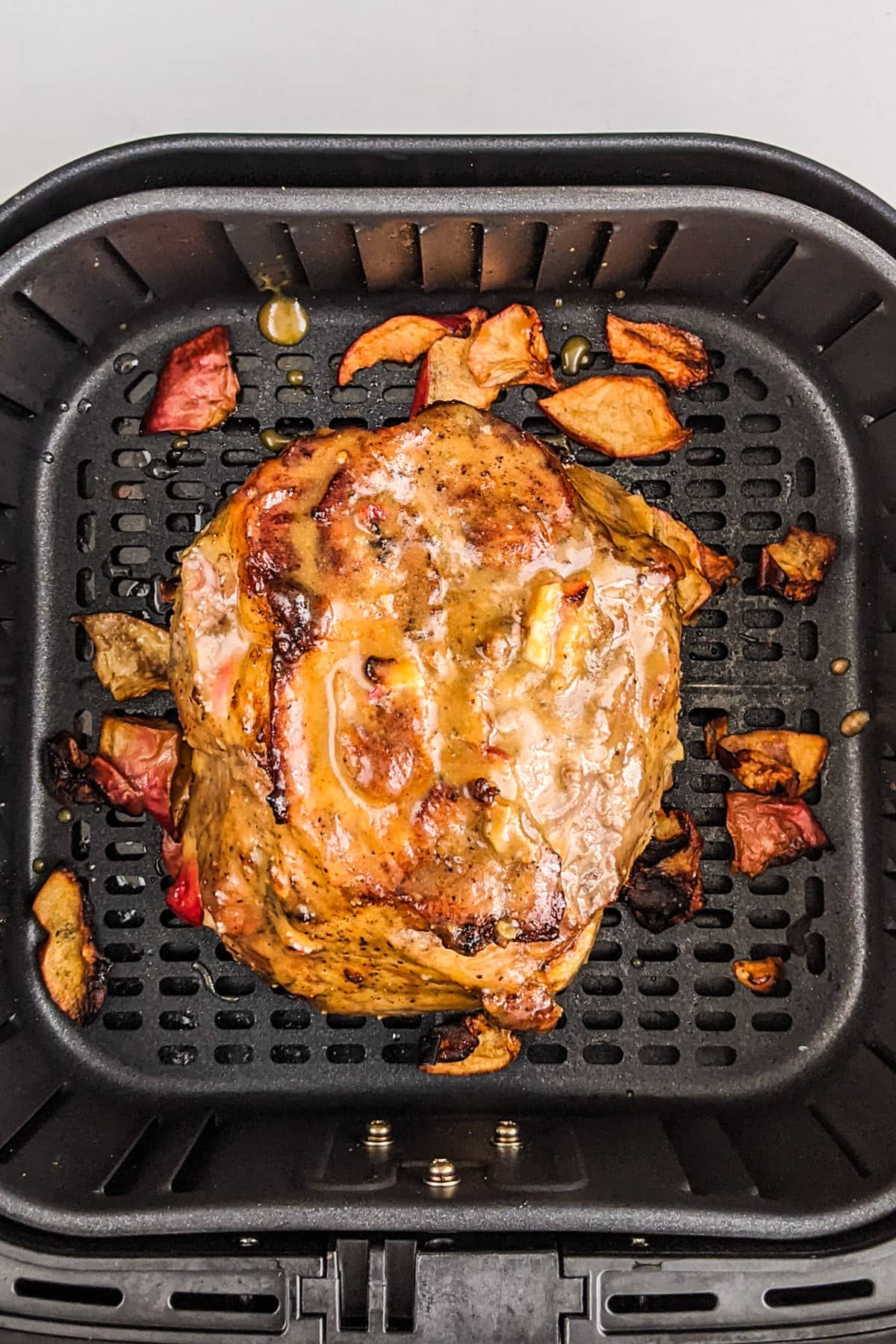 Cooked juicy pork roast with apple slices.