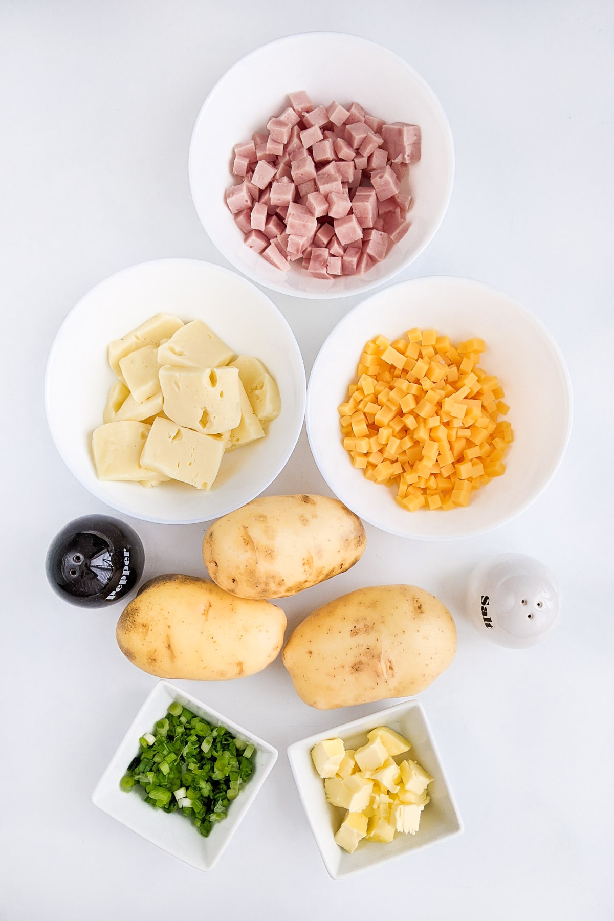 Ingredients for the twice baked potatoes in the air fryer on a white table.