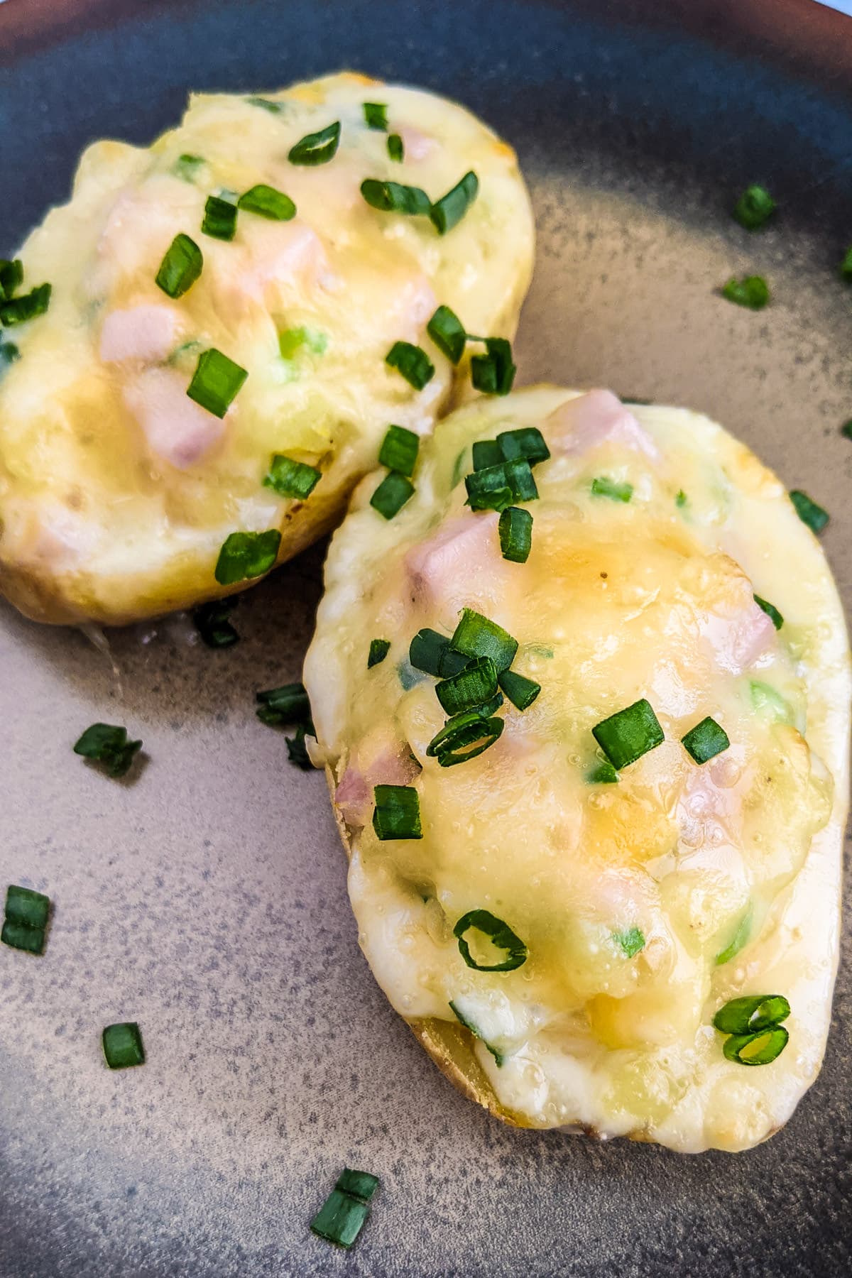 Twice baked potatoes with green onions, ham and cheese.