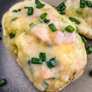 Twice baked potatoes with green onions, ham and cheese.