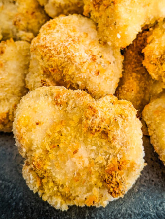 Close view of chicken nuggets coated in breadcrumbs.
