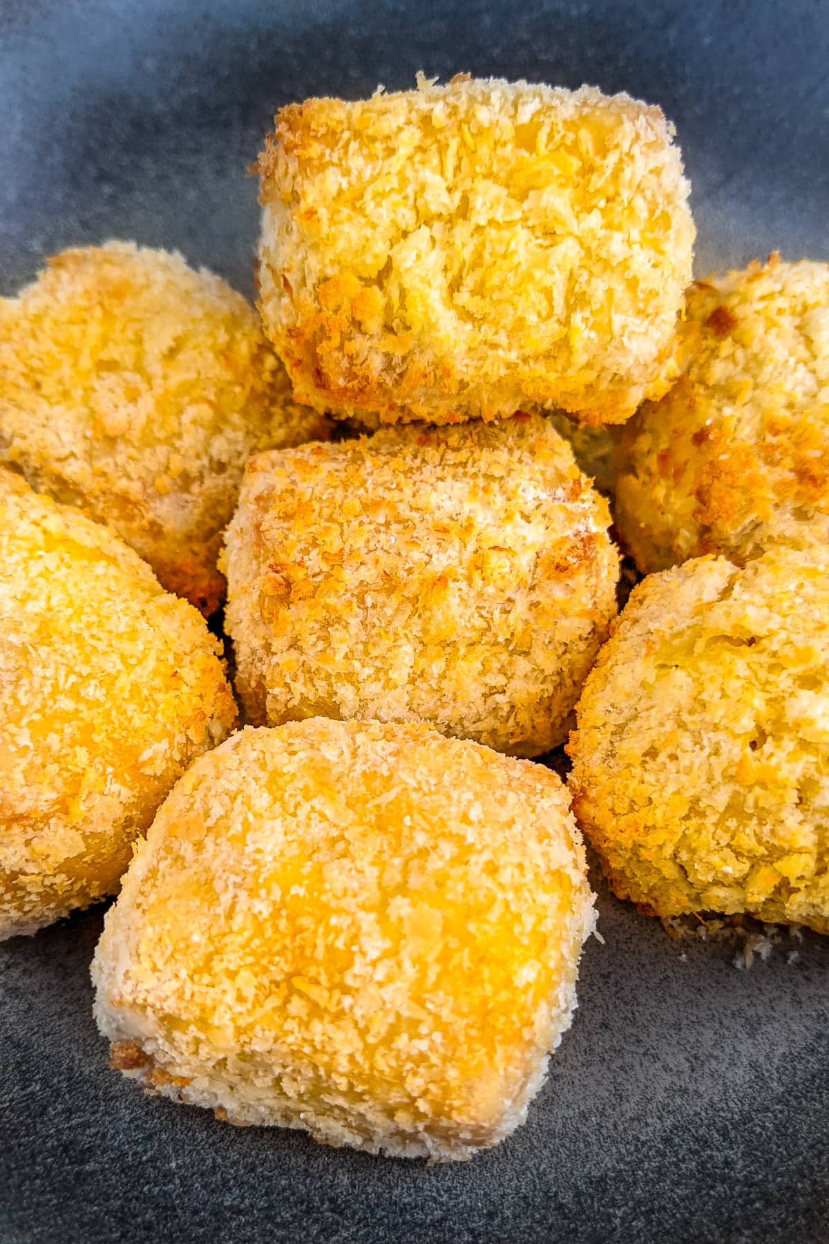 Close look of golden panko nuggets in air fryer.