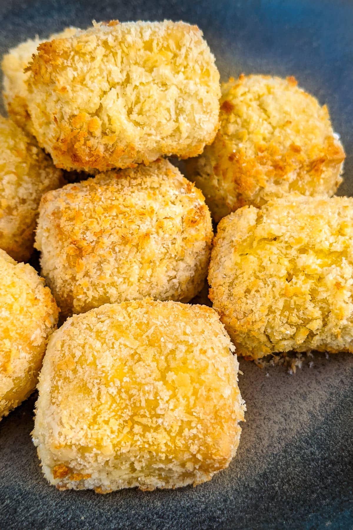 Close look of golden panko nuggets in air fryer.