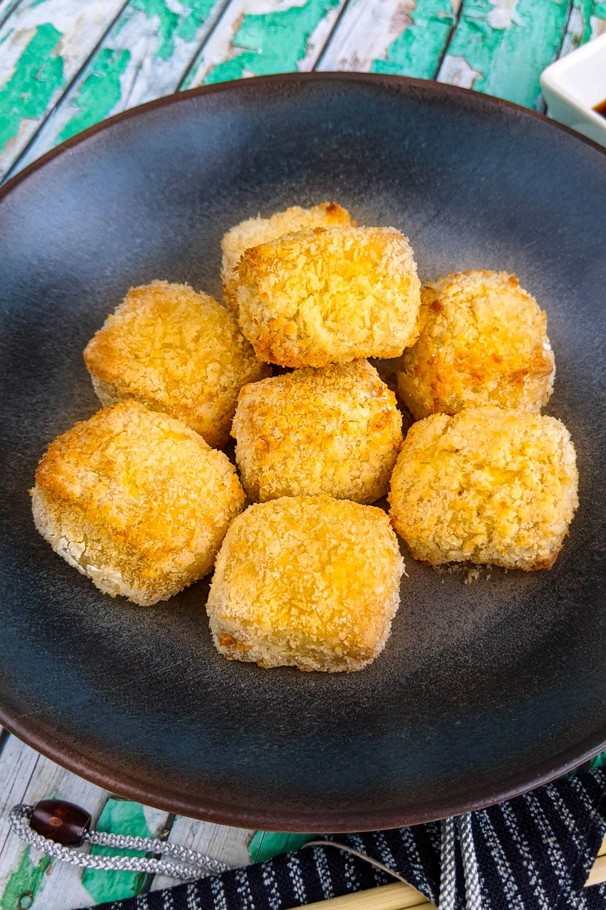 A plate with air fryer tofu nuggets coated in panko.