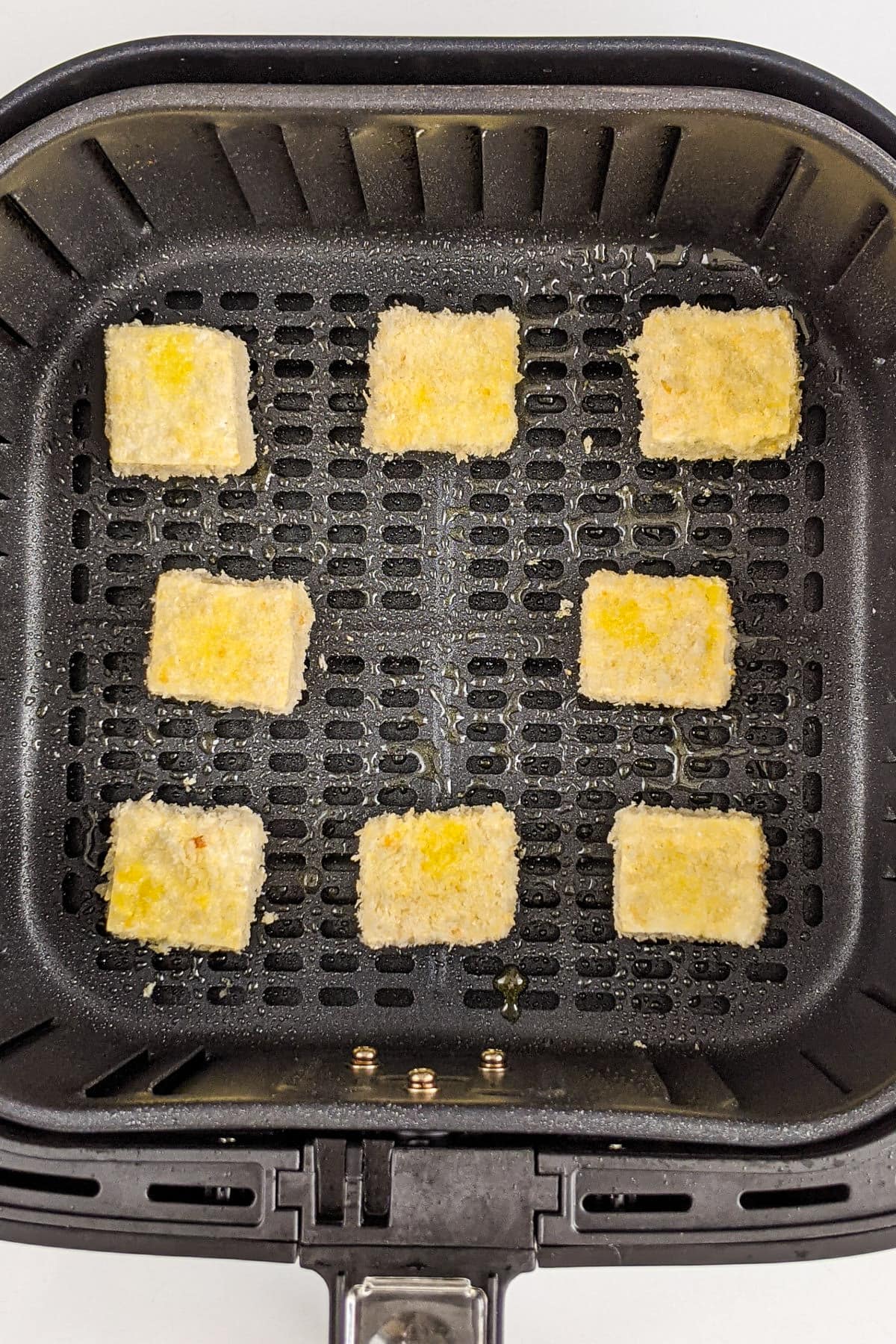 Top view of panko tofu nuggets in the air fryer basket.
