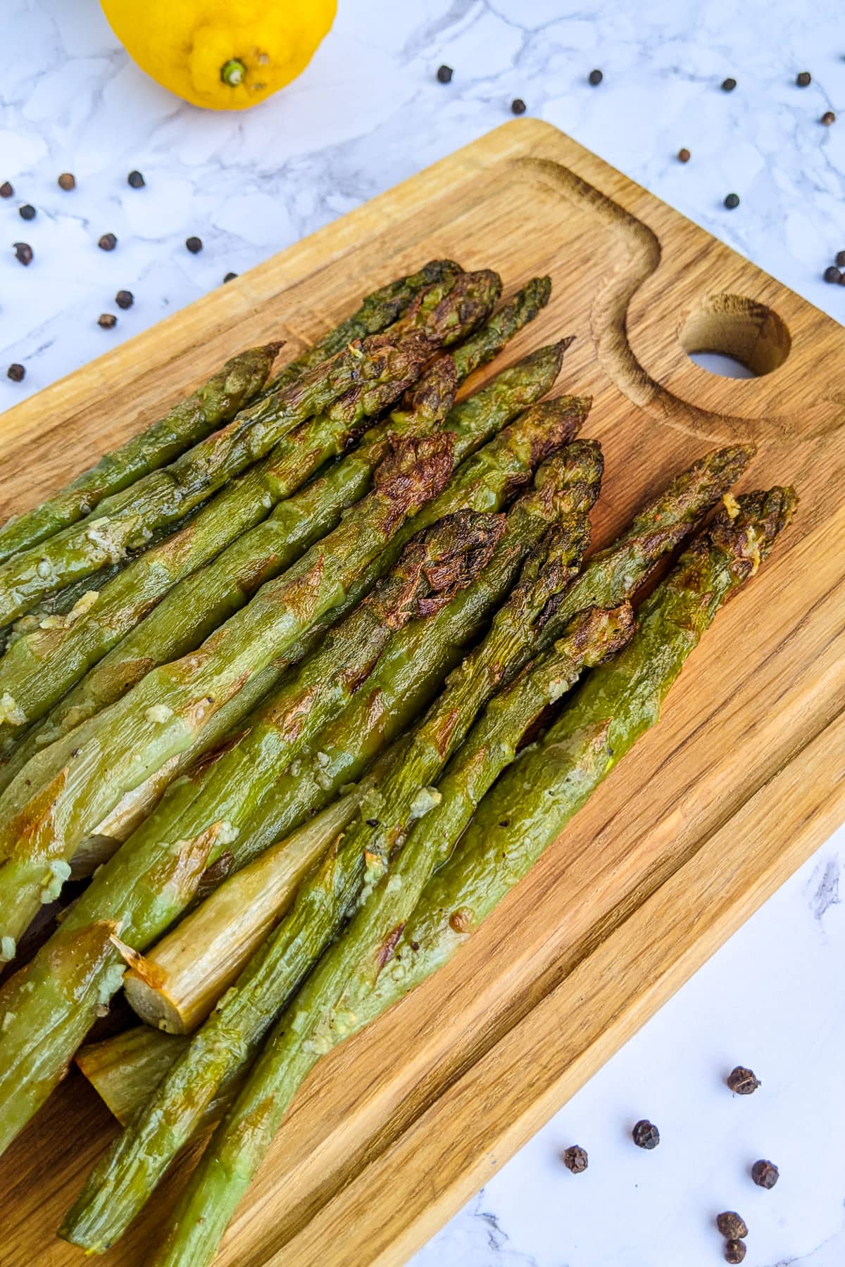 Air Fryer asparagus cooked from frozen on a wooden board.