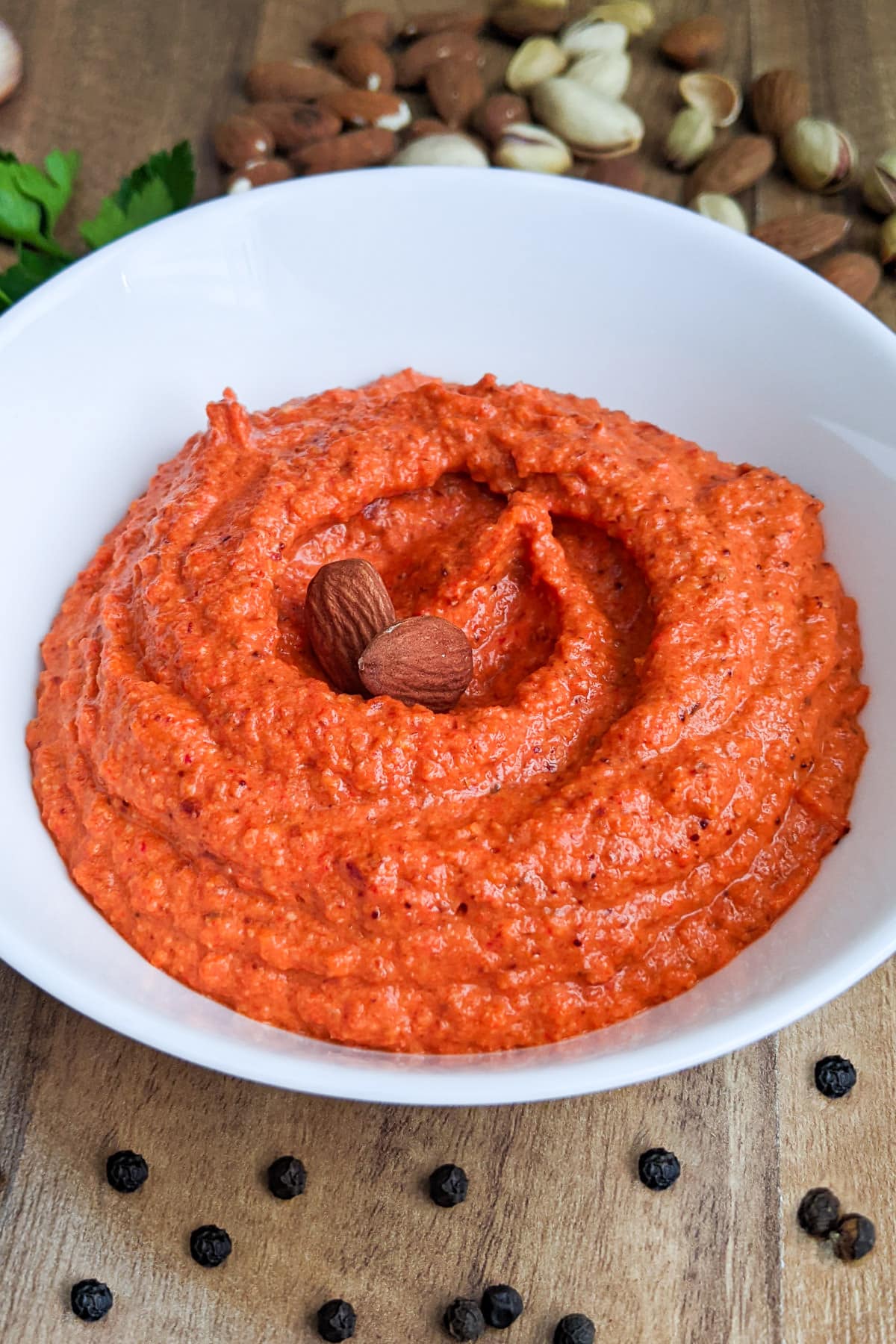 Romesco Sauce with almonds and black pepper on background.