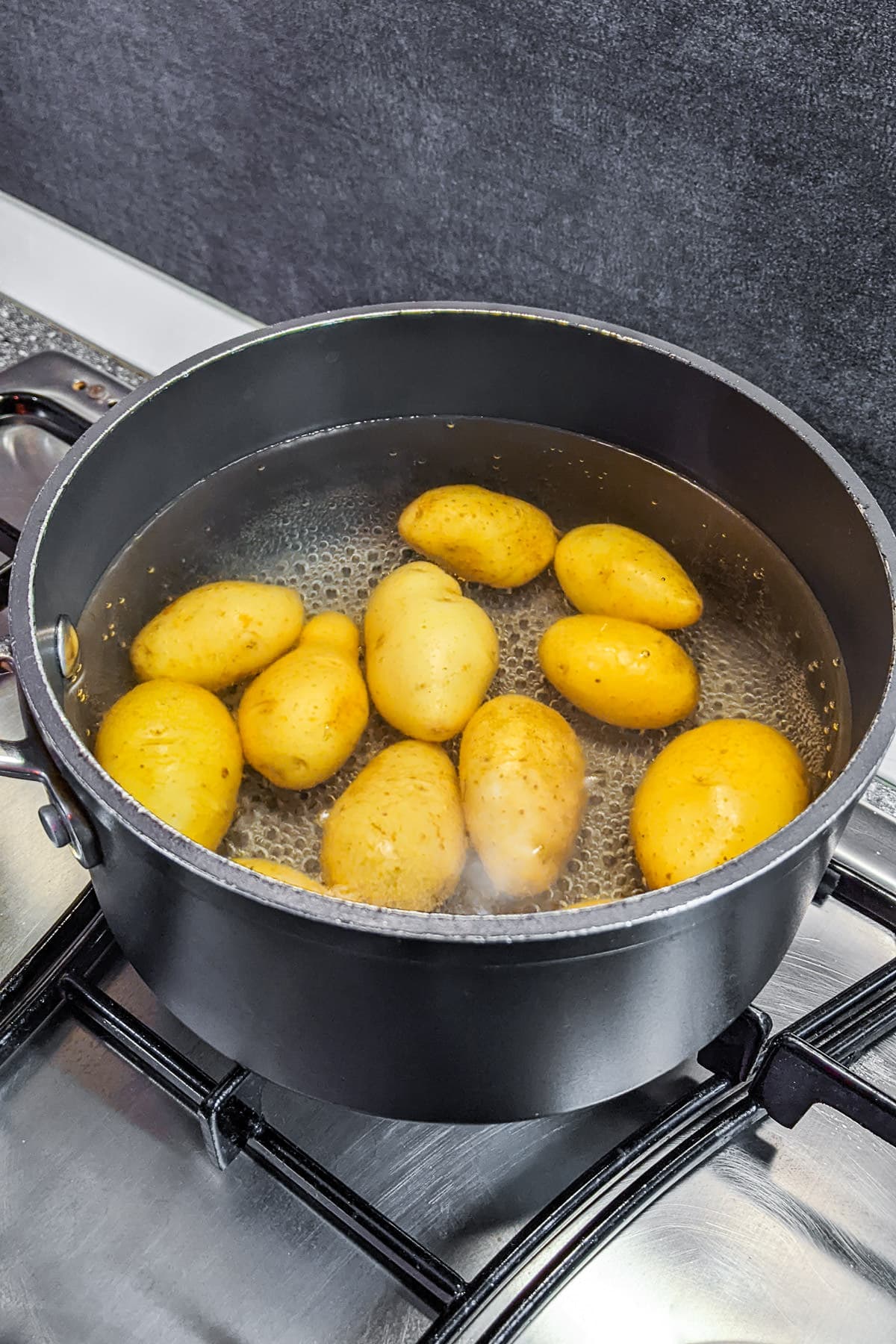 Boiling potatoes on a hob.