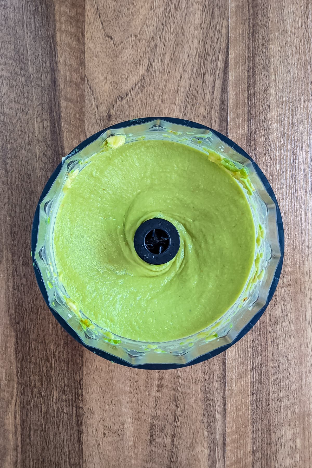 Mixing the creamy avocado sauce in a blender.