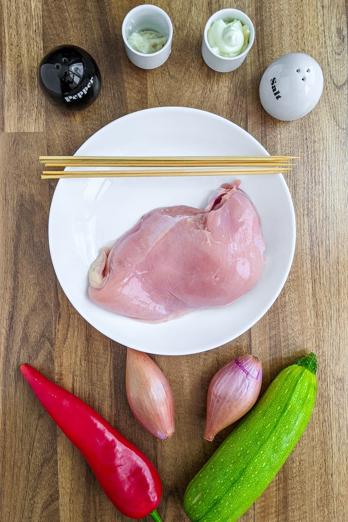 Top view of prepared ingredients for the chicken skewers.